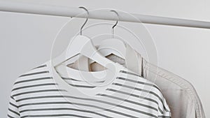 Women's fashion trendy longsleeve, striped sweatshirt, beige denim shirt, jacket on white wooden hanger hangs on