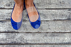 Women`s feet against the background of boards