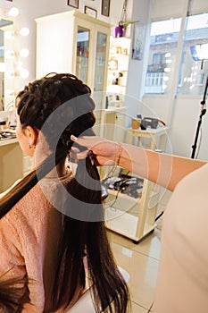 Women`s haircut. hairdresser, beauty salon. Beautiful woman getting haircut by hairdresser in the beauty salon.