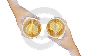 Women`s Hand holding cup of cappuccino coffee with heart shape latte art isolated on white background, Latte coffee on white