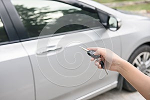 Women`s hand presses on the remote control car systems