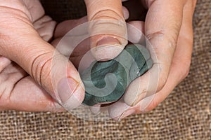 Women's hands with blue clay