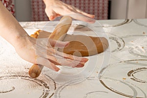 Women`s hands cut out shapes for baking gingerbread cookies