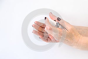 Women `s hands demonstrate how to use an antibacterial spray