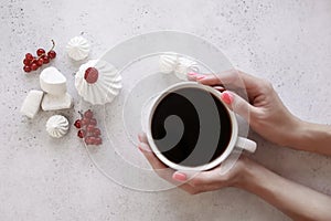 Women`s hands holding a Cup of coffee on a white background.