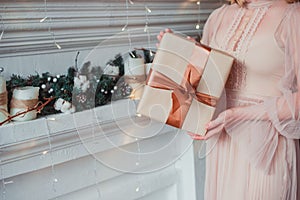 Women`s hands holding a gift in Kraft paper. Christmas concept