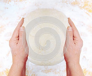 Women's hands knead the dough