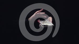 Women`s hands making rich money bill tossing gesture, slow motion