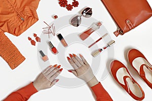 Women& x27;s hands with manicure and items of women& x27;s clothing and accessories.