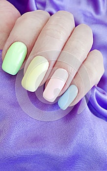 Women`s hands manicure silk fabric stylish