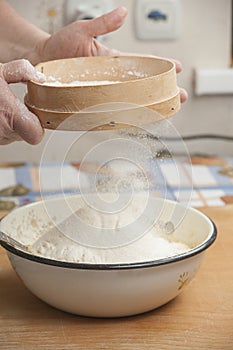 Women's hands preparing flour before baking pie