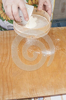 Women's hands preparing flour before baking pie