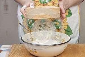 Women's hands preparing flour before baking pie