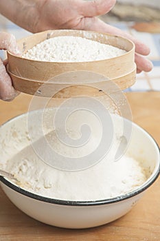 Women's hands preparing flour before baking pie