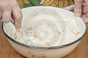 Women's hands preparing fresh yeast dough