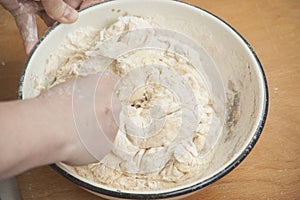 Women's hands preparing fresh yeast dough