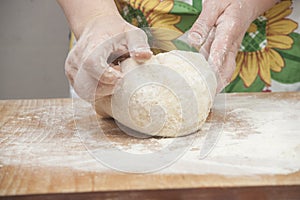 Women's hands preparing fresh yeast dough