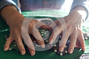 Women's hands shuffle cards. Concept of playing poker on the table with chips and cards. Gambling concept. Enjoying