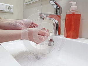 Women`s hands with soap sink splash personal cleanliness