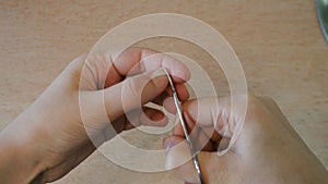 Women`s hands are trimmed nails.