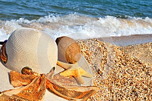 Women`s hat, coconut and starfish.