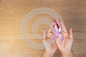 Women`s health care concept. Women hands holding pink bow, pink