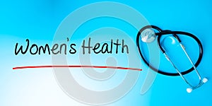 Women`s Health Sign.Text underline with red line. Isolated on blue background with stethoscope. Health concept
