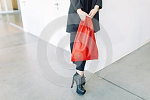 Women`s leather bag in the hands of a stylish girl