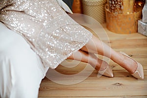 Women& x27;s legs. Cropped close-up photo of healthy beautiful elegant female legs in beige high-heeled shoes, woman