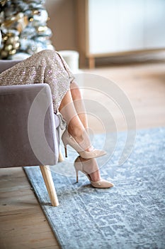 Women& x27;s legs. Cropped close-up photo of healthy beautiful elegant female legs in beige high-heeled shoes, woman