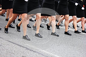 Women`s legs marching. Women in the military parade