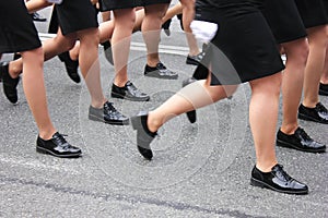 Women`s legs marching. Women in the military parade