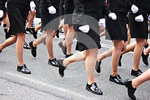 Women`s legs marching. Women in the military parade