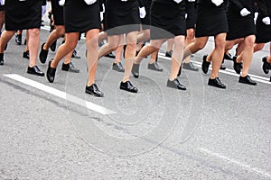 Women`s legs marching. Women in the military parade