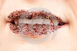 Women's lips with coffee salt scrub for the skin of the lips, exfoliation and lip care yourself at home.