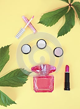 Women`s makeup cosmetics, pink lipstick, light eye shadow, lip gloss and perfume for fragrance