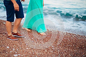 Women`s and men`s feet in the sand