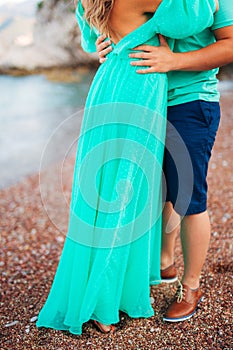 Women`s and men`s feet in the sand