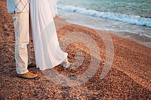 Women`s and men`s feet in the sand