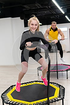 Women's and men's group on a sports trampoline, fitness training, healthy life - a concept trampoline group