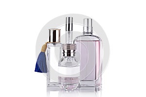 Women`s perfume bottles on a white background with reflection, isolated