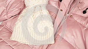 Women`s pink down jacket, hat. top view. Autumn, winter women`s clothing fashion concept