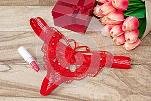 Women`s red butterfly strings, lipstick and bouquets of tulips. Set a date. Valentine`s Day