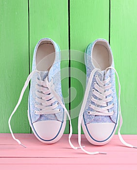 Women's retro hipster sneakers with white laces on a pink wooden