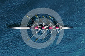 Women`s rowing team on blue water