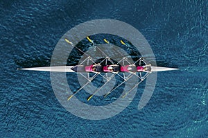 Women`s rowing team on blue water photo