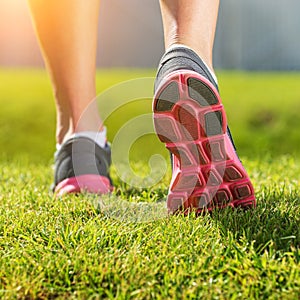 Women's running legs, pink-gray sports shoe detail