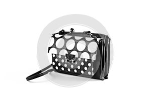 Women`s small black handbag with white circles. Close up. Isolat