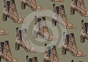 Women`s Snakeskin Cowboy Boots isolated on green background. Snake Cowboy Ankle Boots pattern. Close View Of Fashion