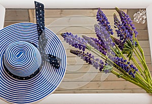 female, vacation,blue lupine flowers on a wooden background